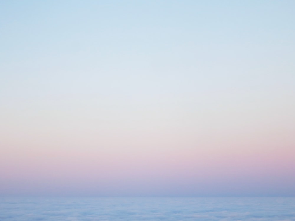 a body of water with a blue sky above it