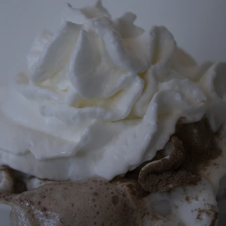 A creamy cheese foam tea with a smooth, frothy layer and a sprinkle of cocoa powder.