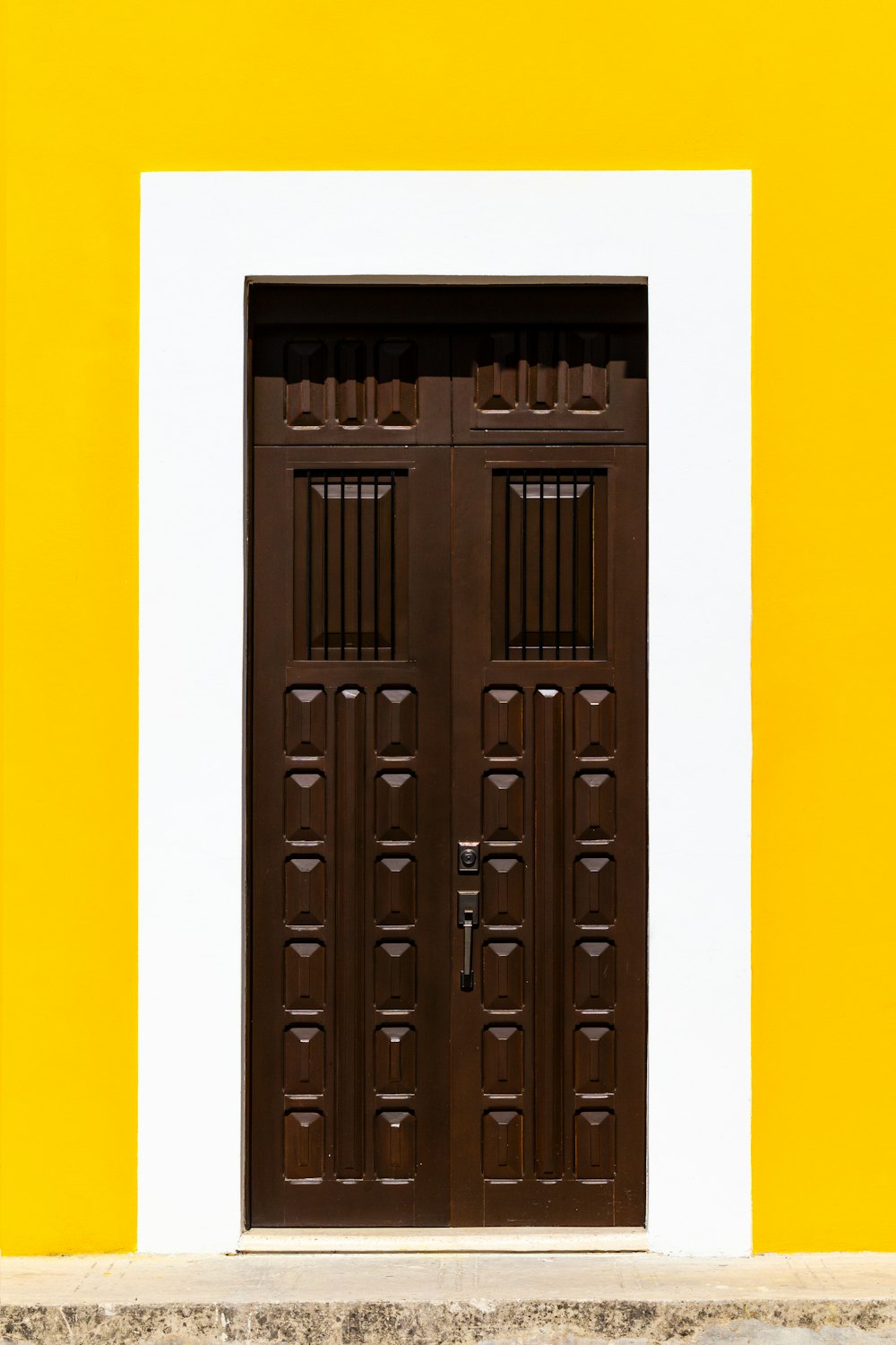 a black door with a yellow background