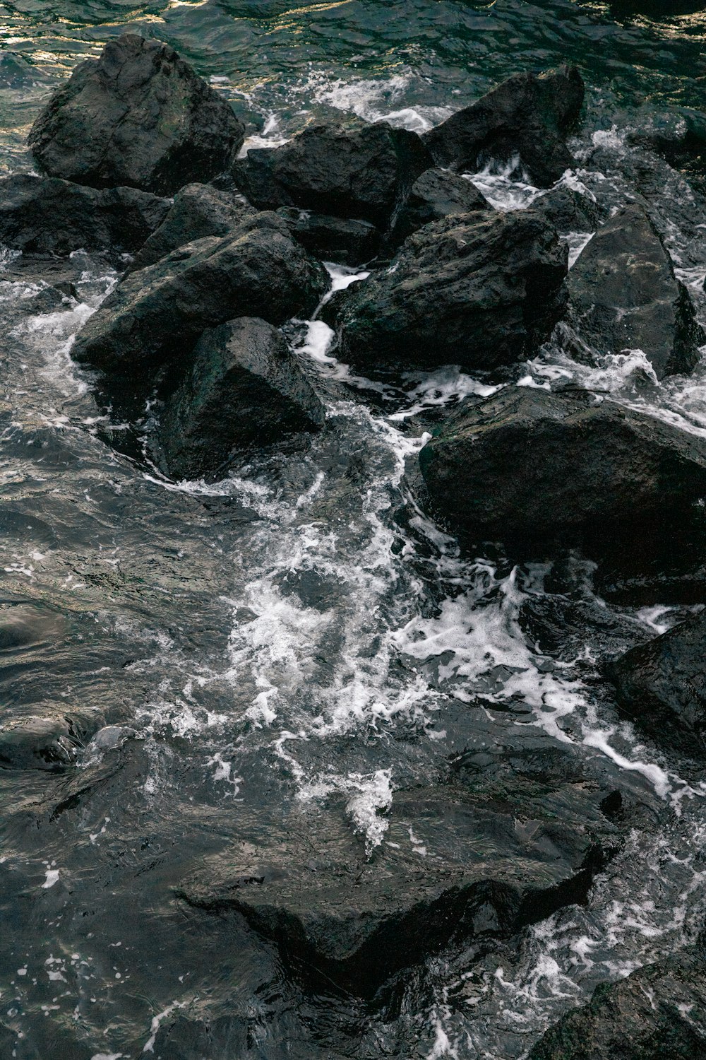 a rocky river with a waterfall