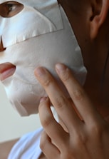 a close-up of a person holding a white towel