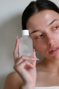 a woman holding a bottle