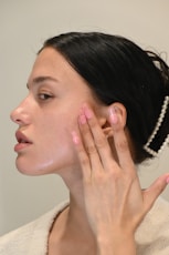 a woman with her hand on her face