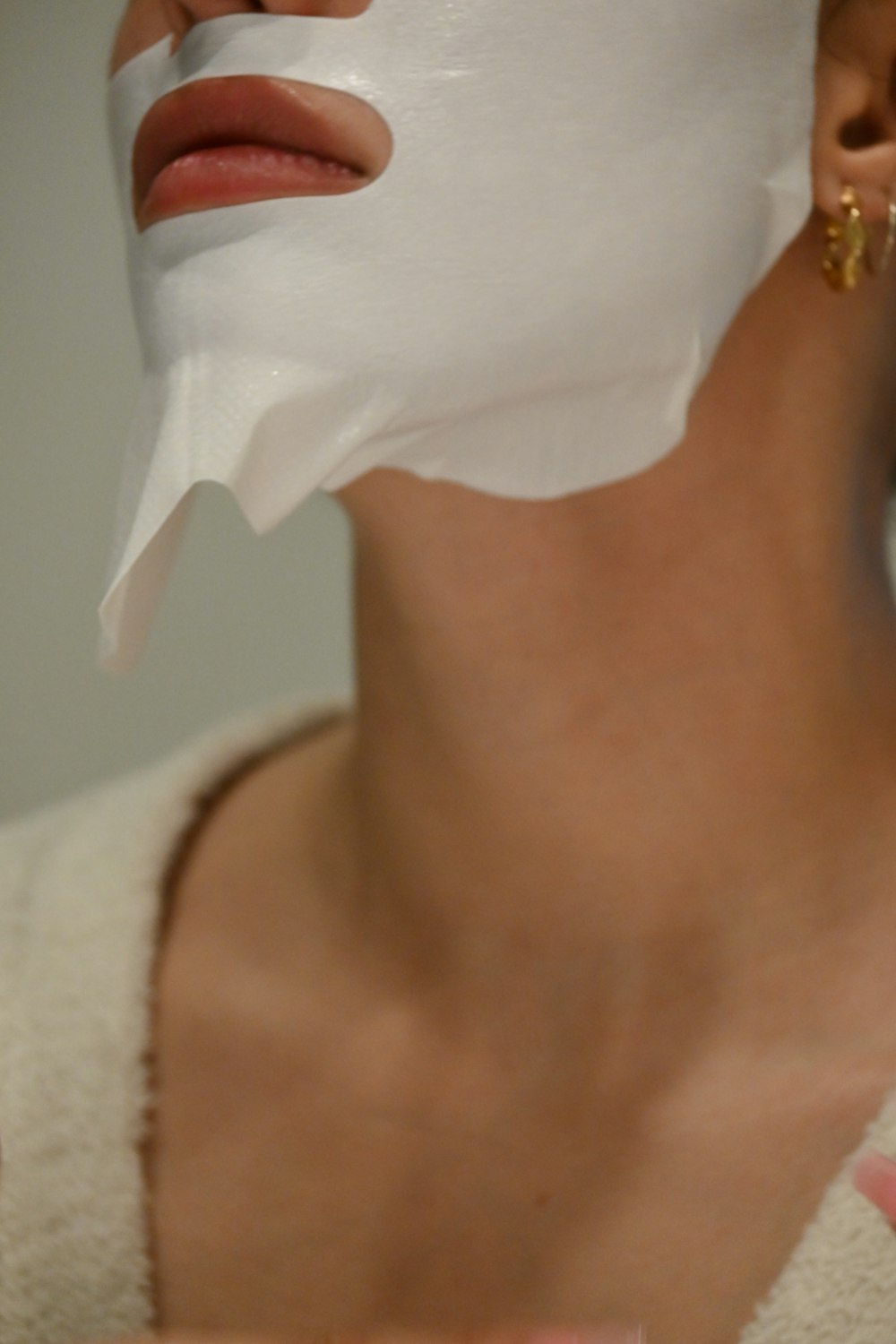a woman with a sheet of white paper on her face