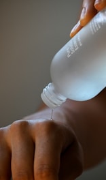 a person holding a bottle of water in their hand