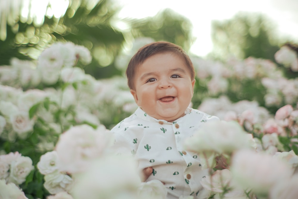 a baby in a field of flowers