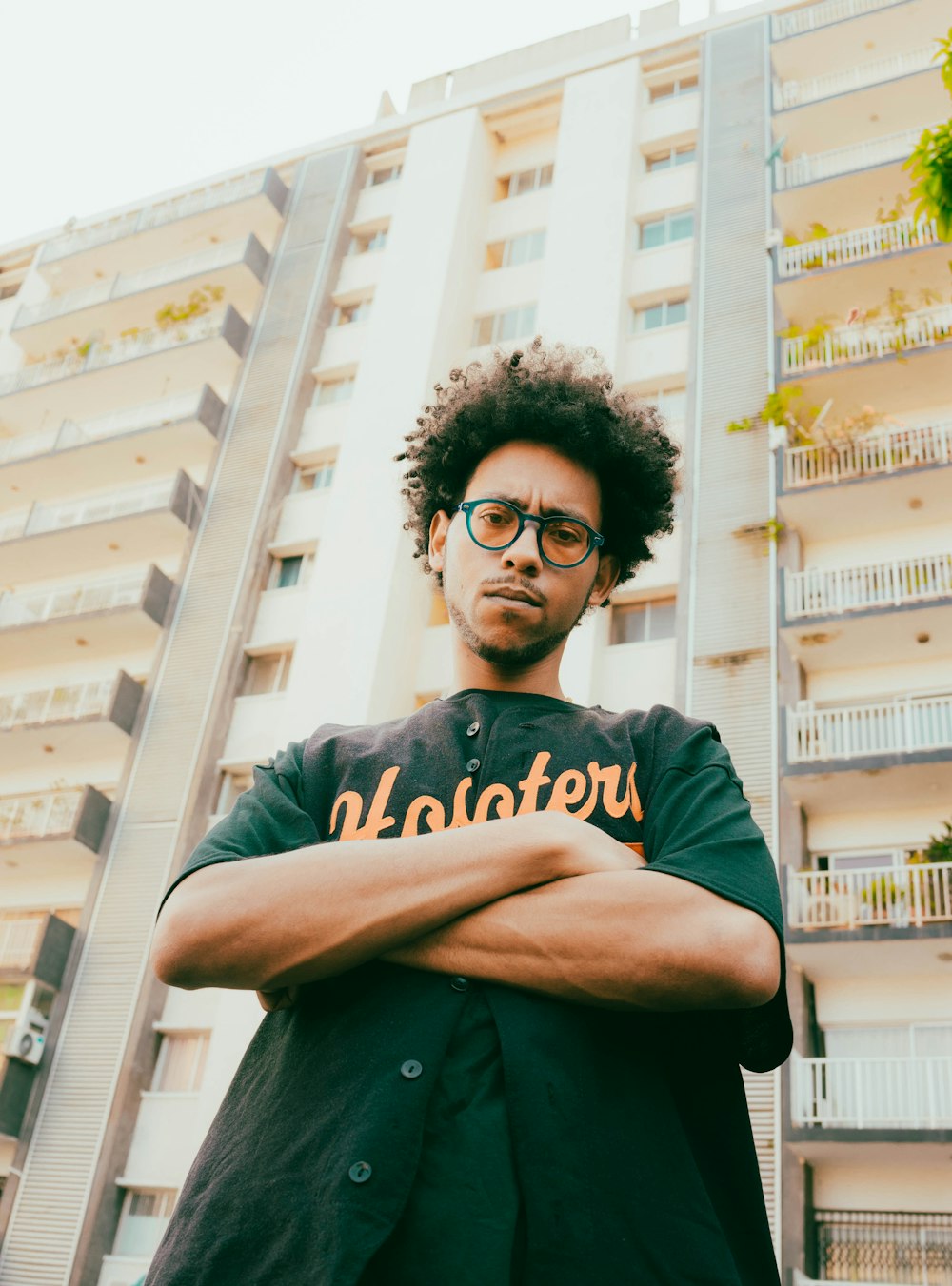 a man with curly hair wearing glasses