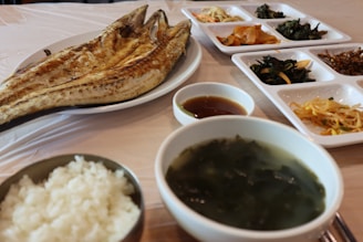 An elegant display of assorted Korean side dishes, known as banchan, served in small bowls.