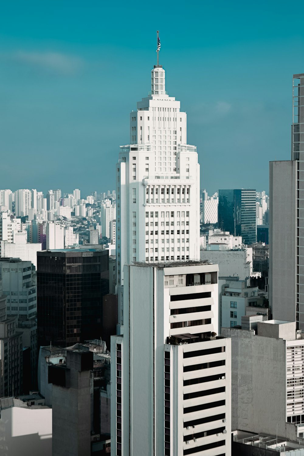 a tall white building in a city