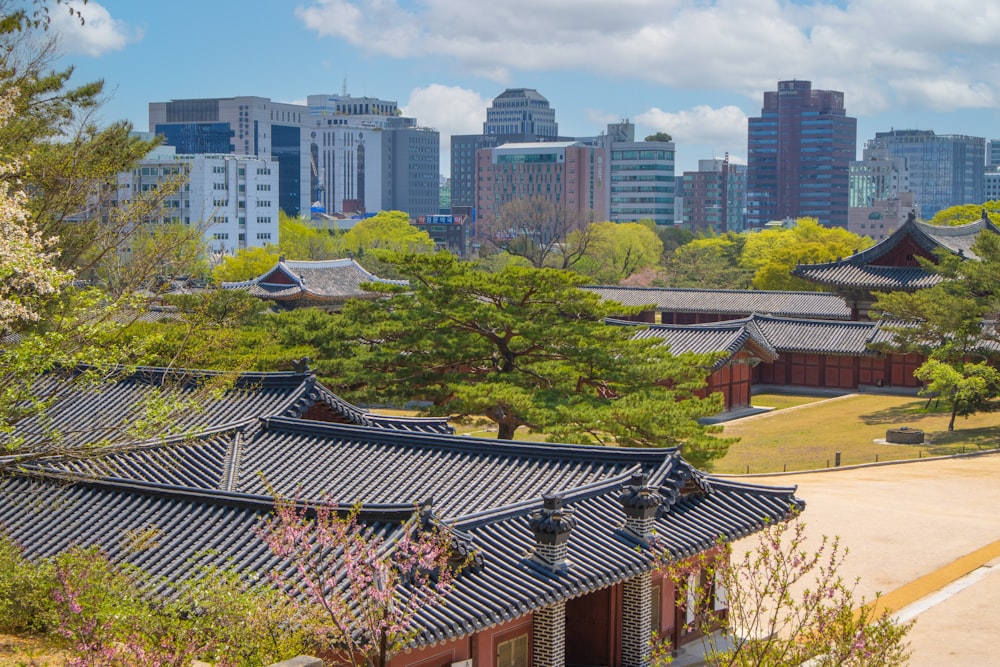 a rooftop of a building with trees and a city in the background