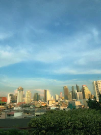 A scenic view of a bustling Latin American city skyline with warm sunlight and a diverse group of professionals collaborating outdoors.