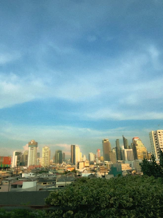 A scenic view of a bustling Latin American city skyline with warm sunlight and a diverse group of professionals collaborating outdoors.
