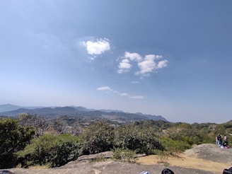 A scenic travel destination with tourists enjoying a guided tour under clear skies.