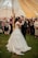 A joyful couple dancing at their wedding reception surrounded by elegant decor.