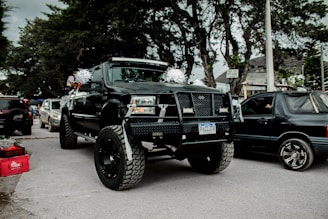 A happy winner holding the keys to a shiny new GMC truck with social media icons floating around.