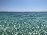 A serene turquoise sea view with a clear blue sky at Karaöz beach.