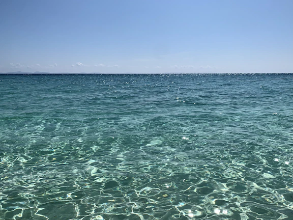 A serene turquoise sea view with a clear blue sky at Karaöz beach.