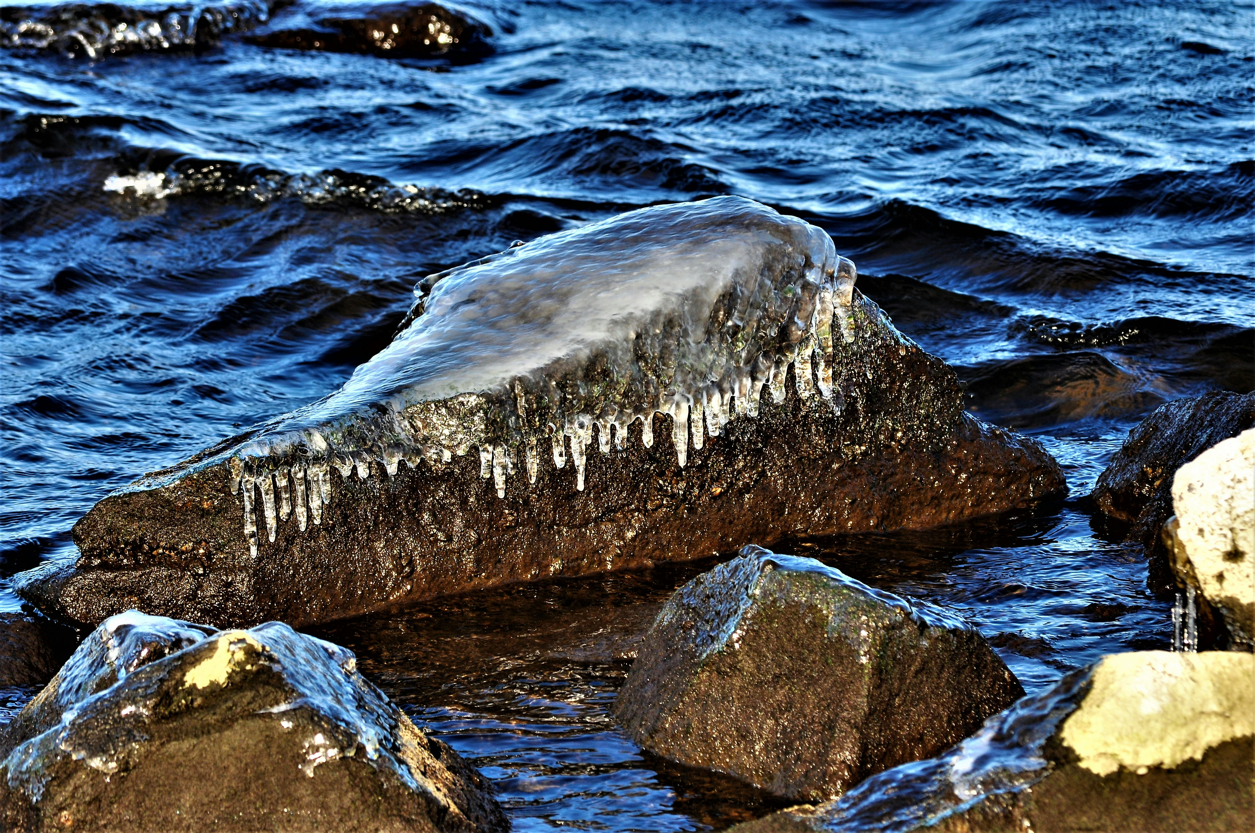 a large rock in the water