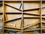 Handmade wooden bookshelf with unique, asymmetrical shelves.