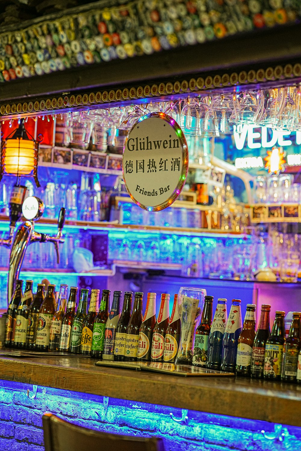 a bar with a sign and bottles of alcohol