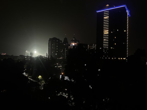 A nighttime cityscape with highlighted properties meeting compliance standards.
