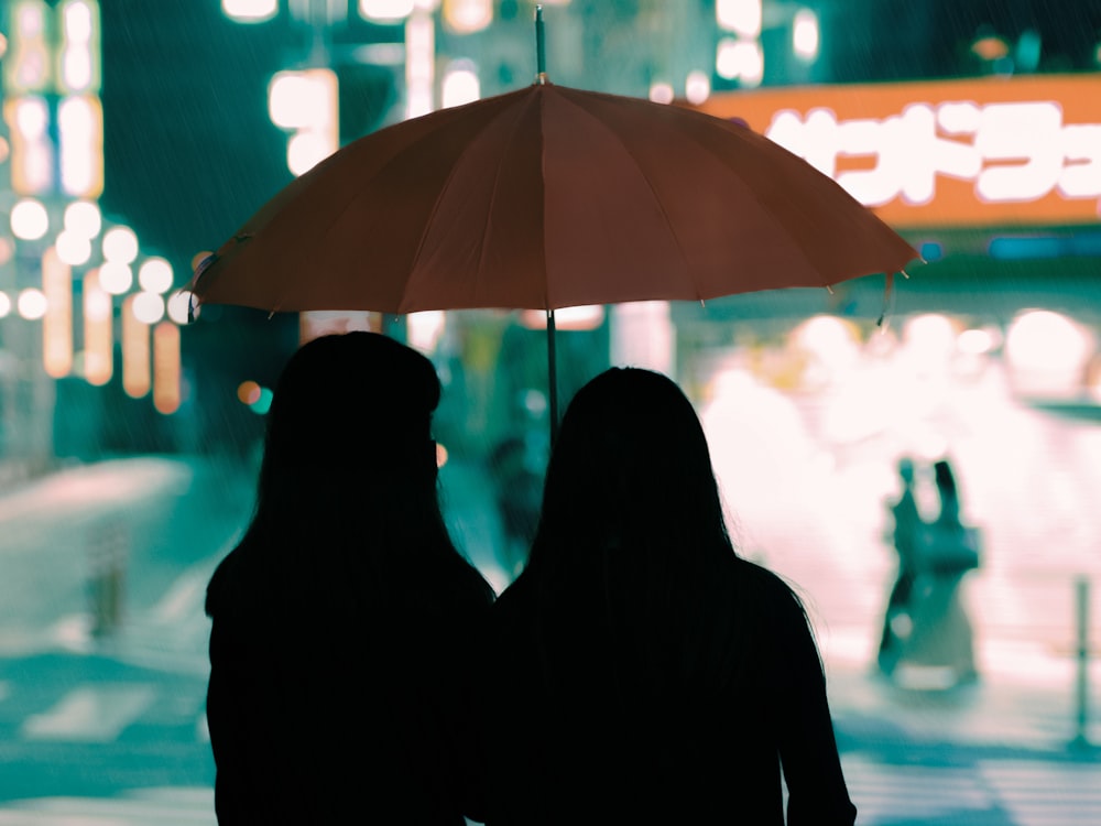 a couple of people under an umbrella