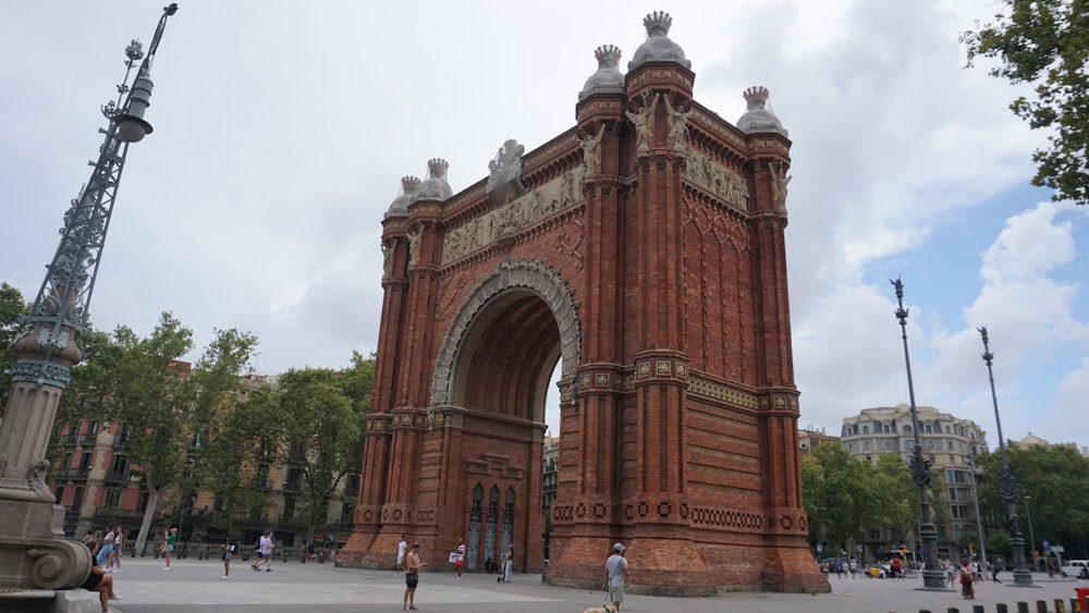 a large stone structure with a dome with Arc de Triomf in the background