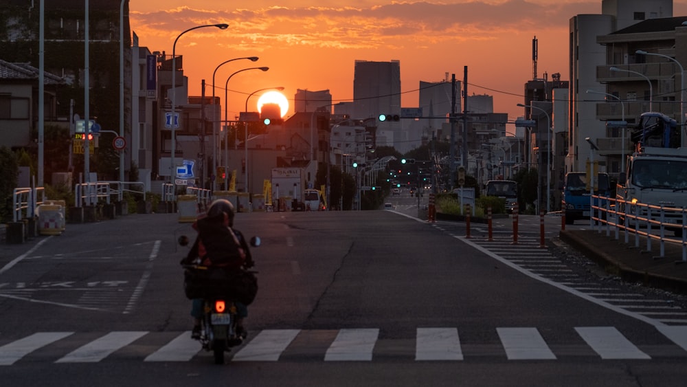 a person riding a motorcycle down a street