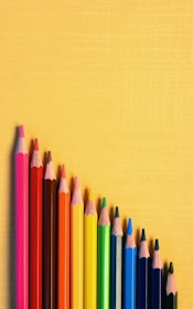 a group of colored pencils