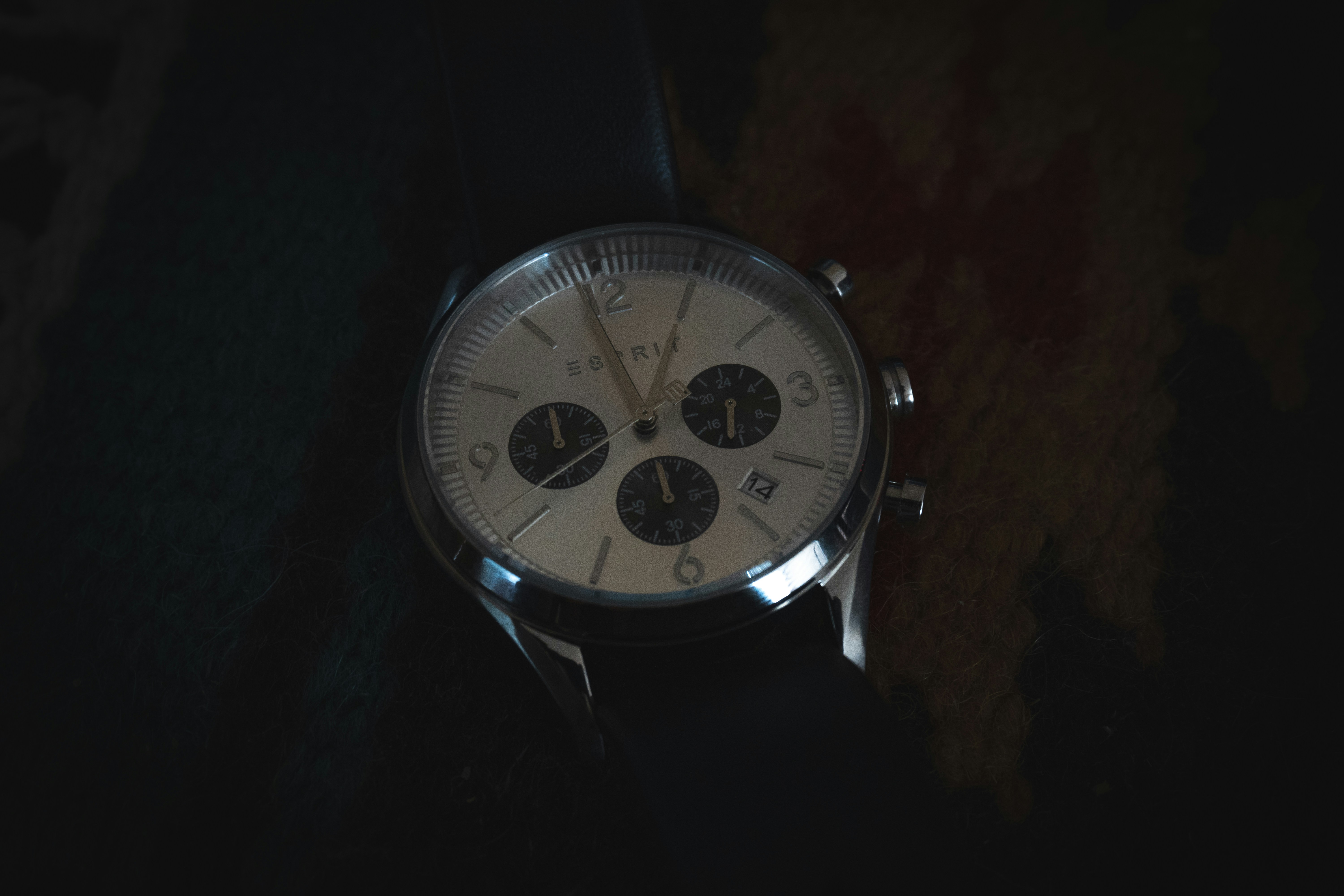 a silver watch with a black band