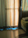 Close-up of plush bedding with soft beige and olive green tones in deluxe room.