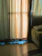 A cozy living room with light filtering softly through beige linen curtains.