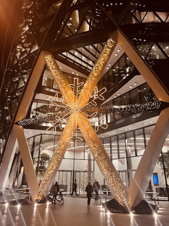 Snowflake LED light decoration glowing softly on a building facade at night