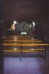 A peaceful chapel prepared for a full funeral service with floral arrangements.