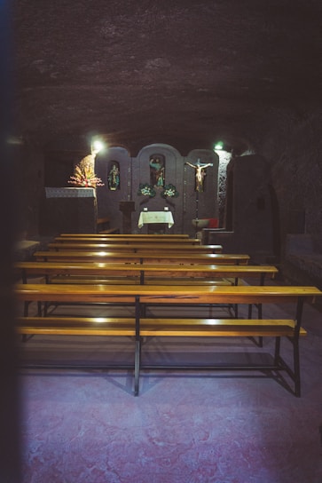 A peaceful funeral chapel with soft lighting and floral arrangements.