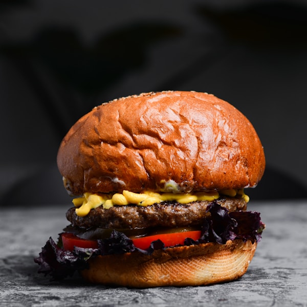 A burger with cheese and vegetables
