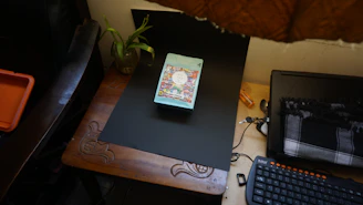 A colorful desk with a laptop, notebooks, and playful stationery arranged neatly.