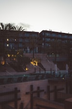 Evening shot of the retreat’s exterior with soft lighting and palm trees.