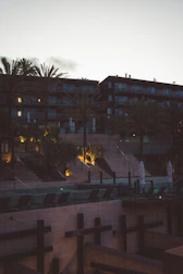 Guests enjoying a serene outdoor lounge area with soft lighting at dusk.