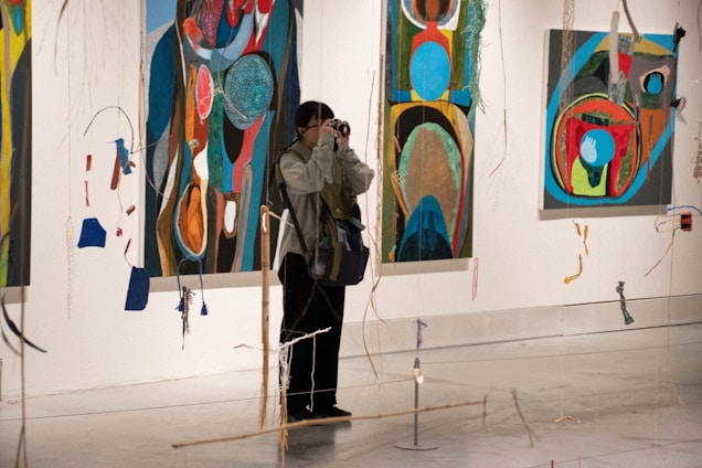a person taking a picture of paintings