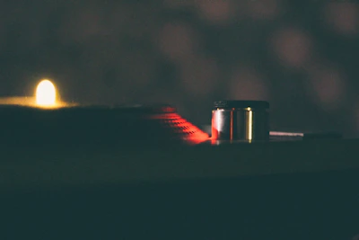 Close-up of glowing turntables illuminated by soft lime gradients.