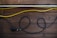 Close-up of a thick, durable power cable coiled neatly on a wooden surface.
