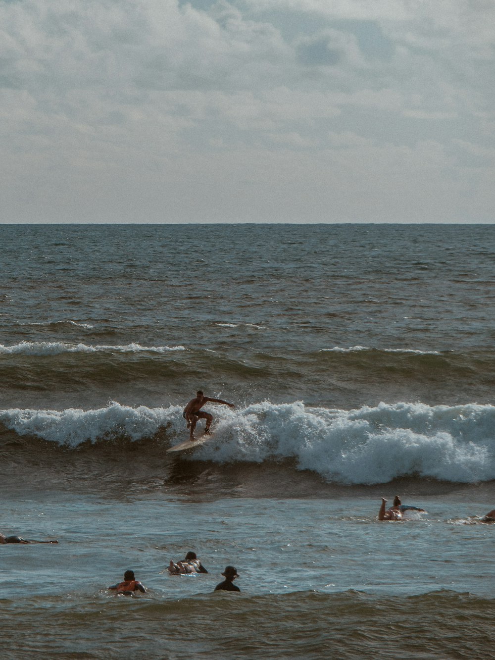 a group of people surfing in the sea