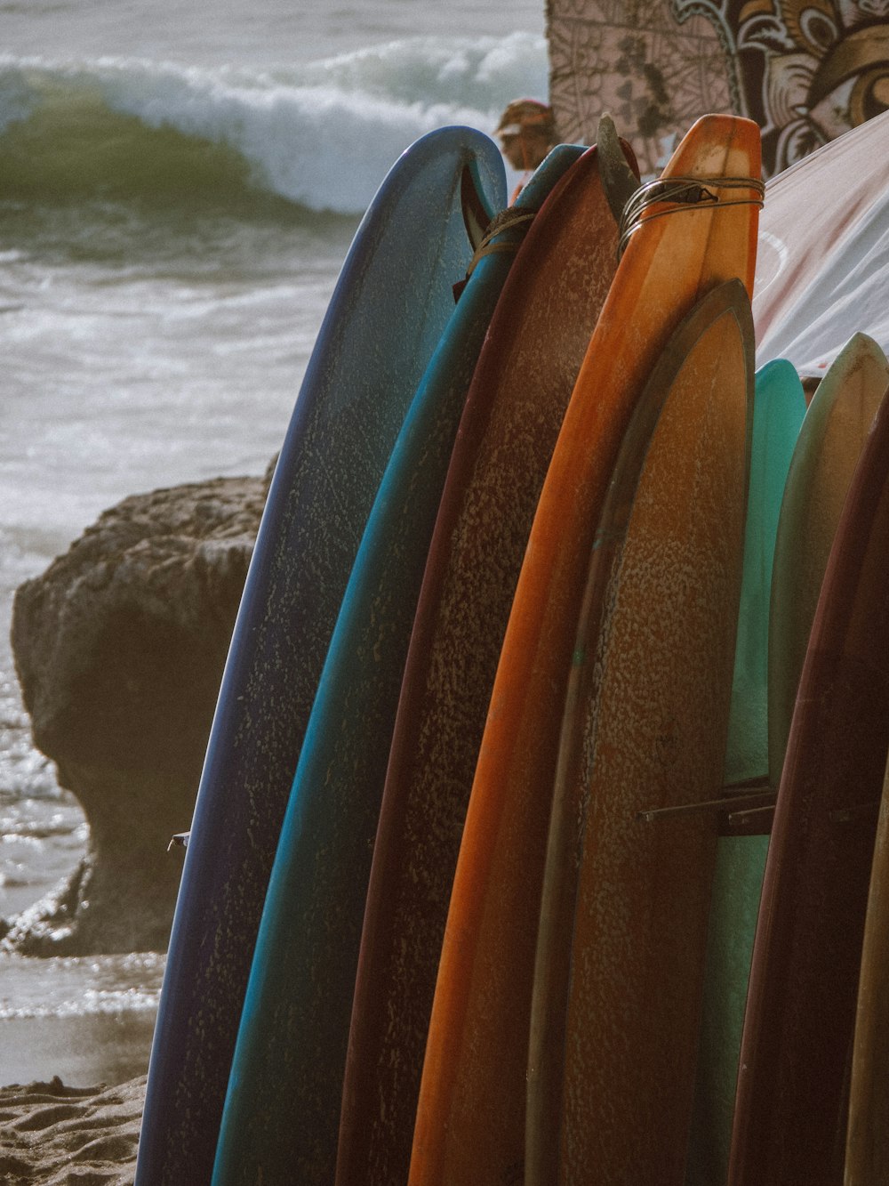 a group of surfboards on a beach