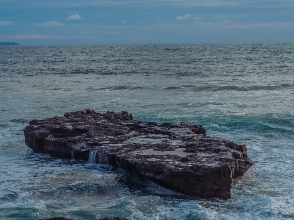 a large rock in the ocean