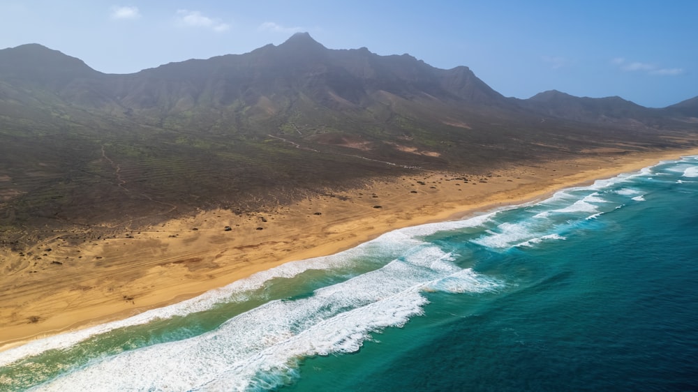 a beach with a mountain in the background