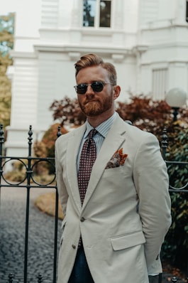 a man wearing sunglasses and a suit
