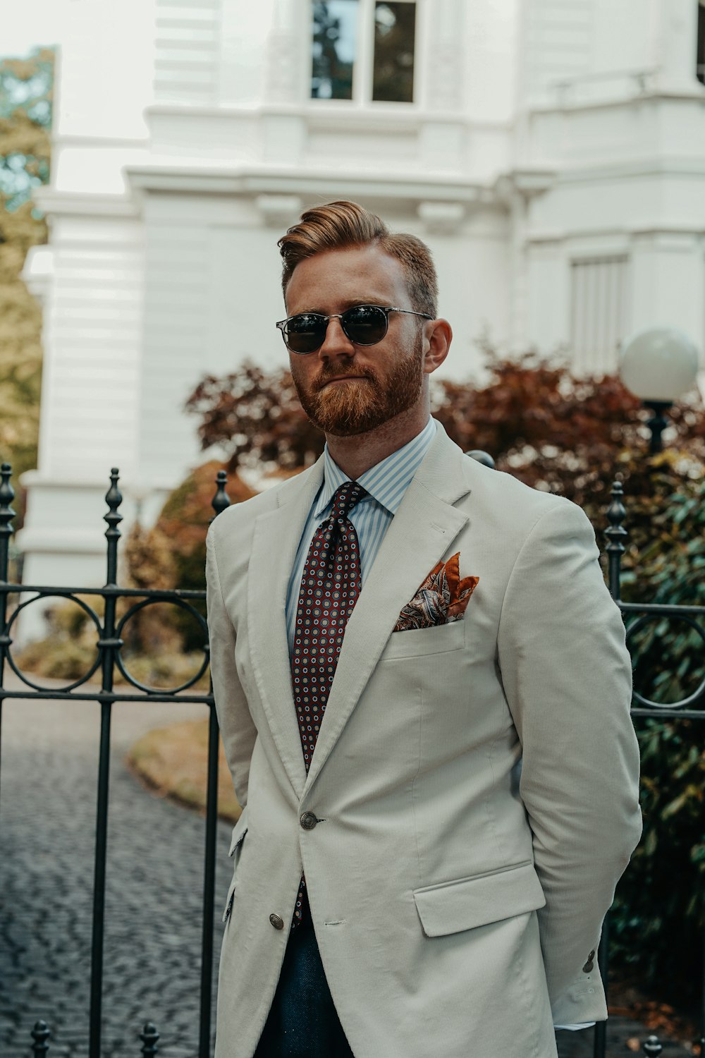 a man wearing sunglasses and a suit