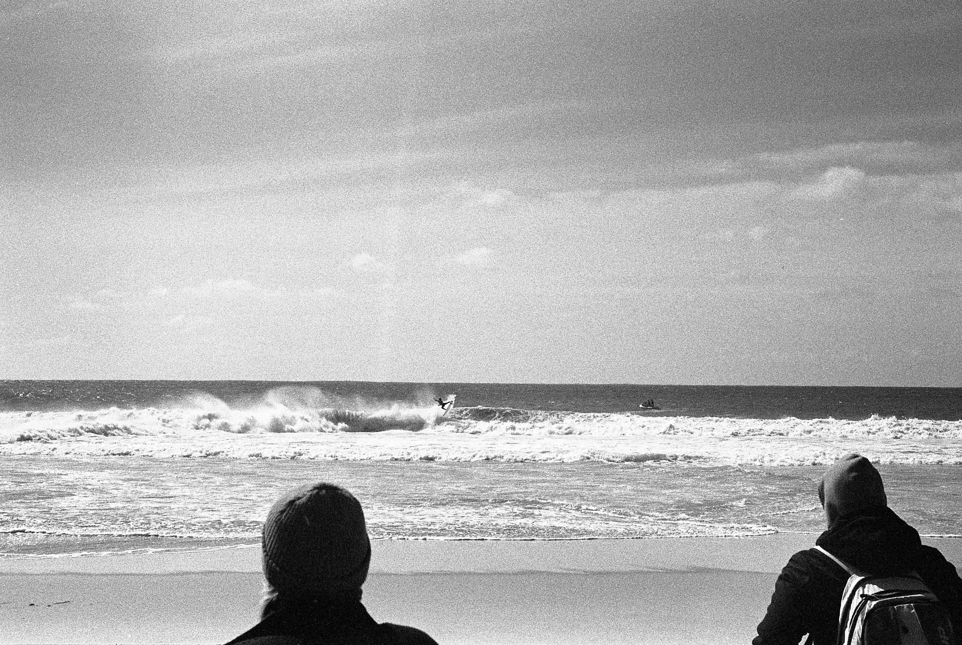 people watching a surfer