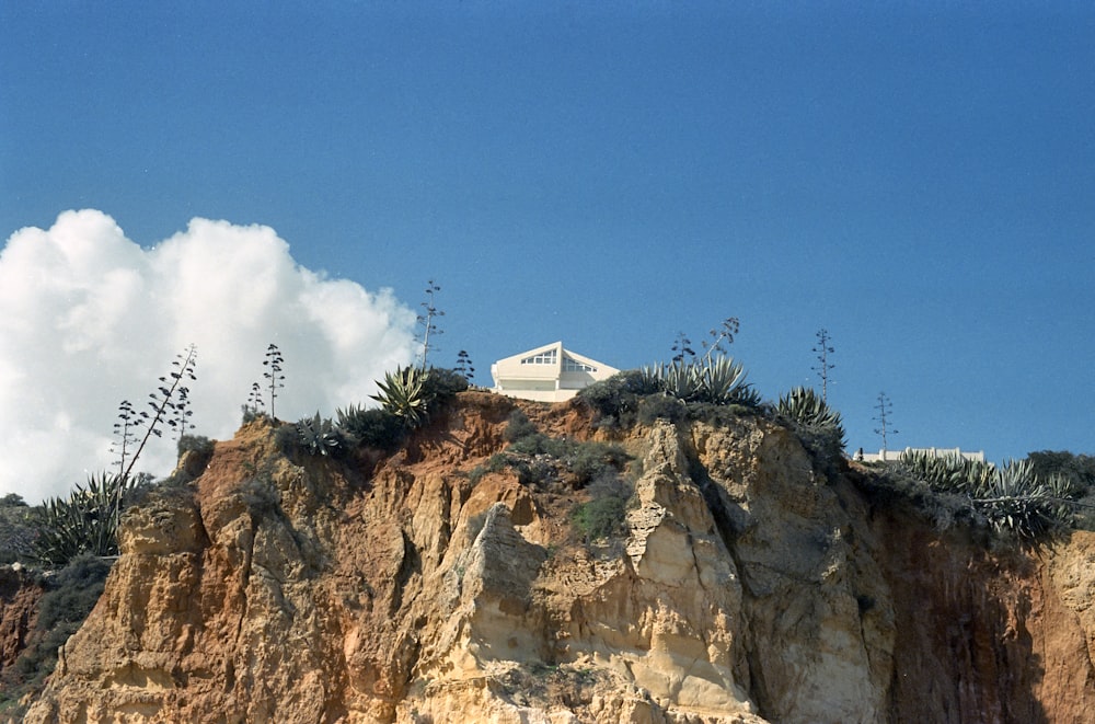 a white building on a rocky hill